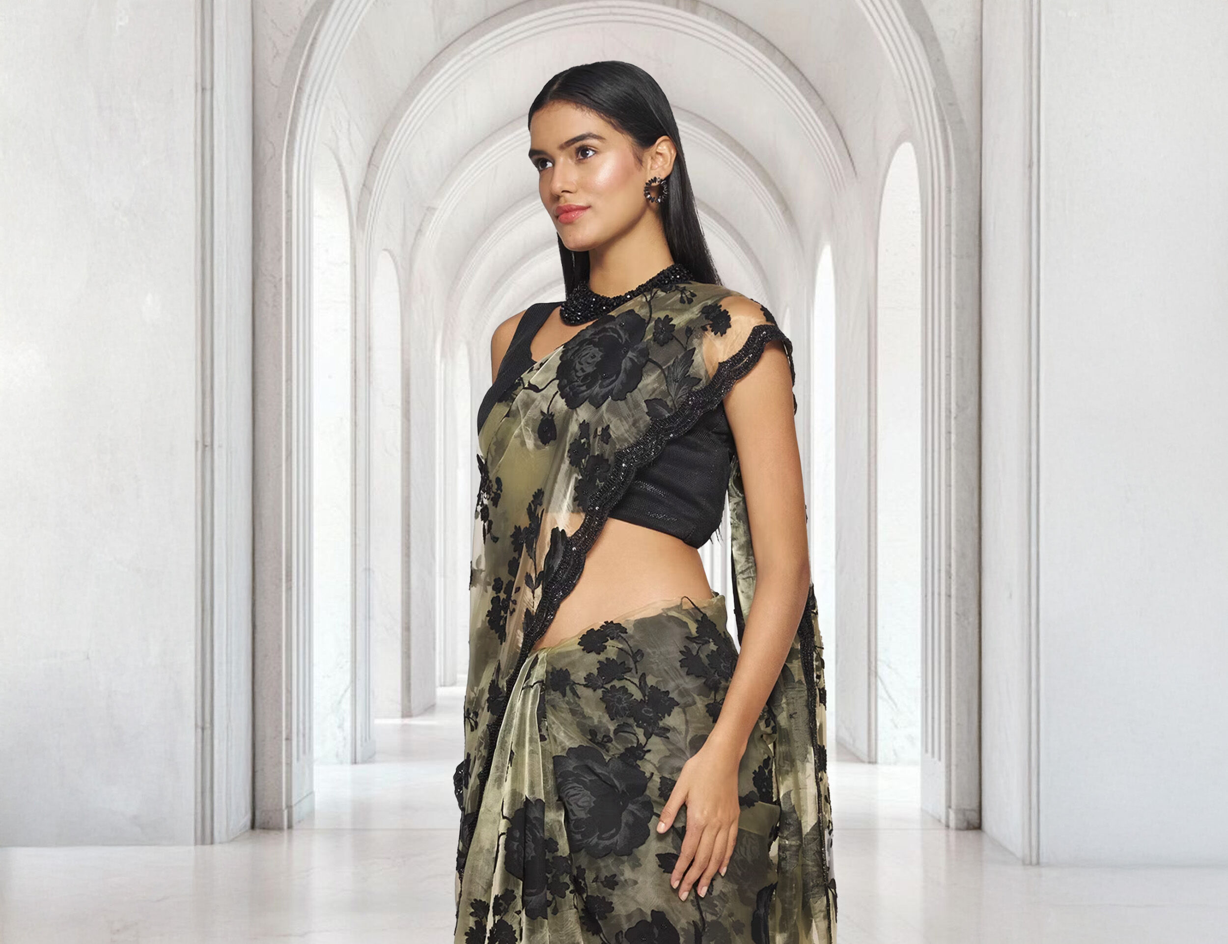 A woman flaunting a beautiful black designer saree